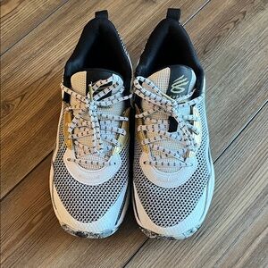 “Curry” Under Armour Kids black, white, and gold Lace-Up Sneakers